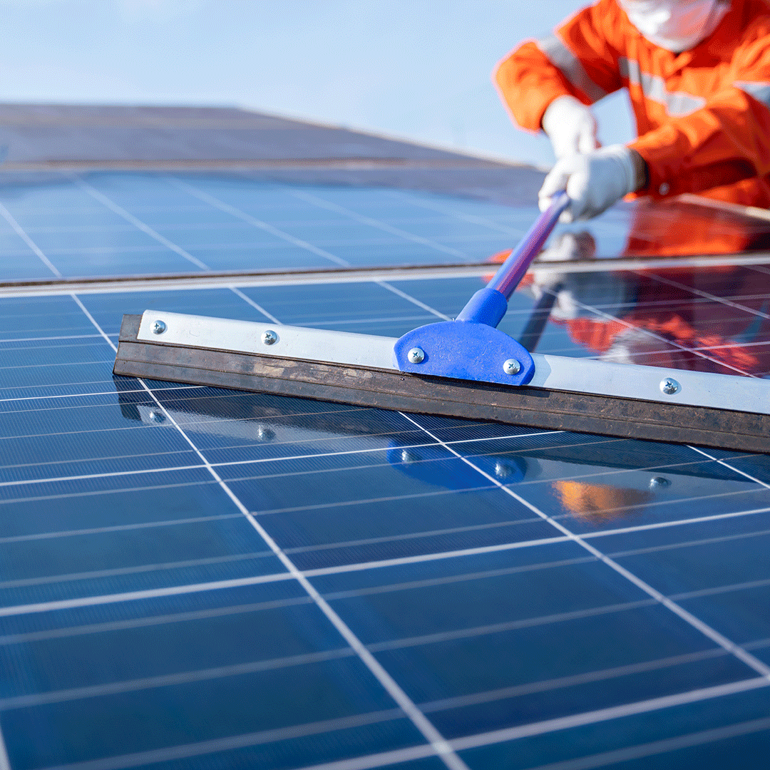 Technician using a digital multimeter to inspect and maintain a solar panel electrical system, ensuring optimal performance and efficiency.